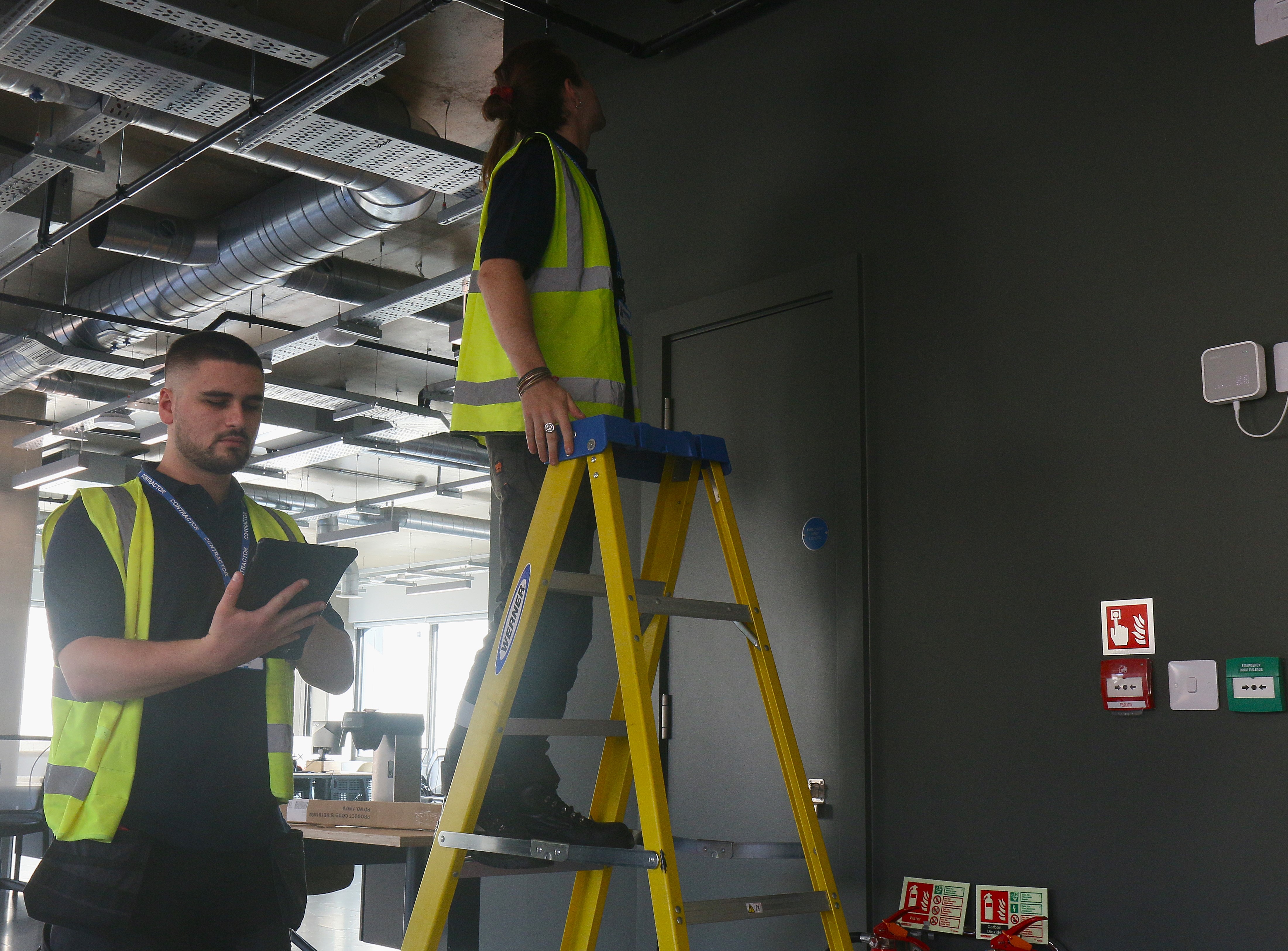 Harry and James inspecting a fire vent